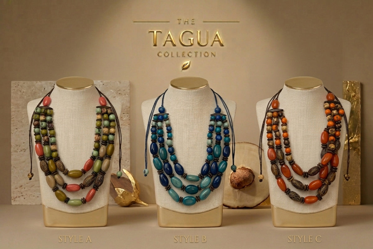 Three beaded necklaces displayed on cream fabric mannequin busts against a warm beige background, with the text 'THE TAGUA COLLECTION' above. The necklaces are labeled Style A, Style B, and Style C, featuring different bead combinations in green, red, blue, and orange.
