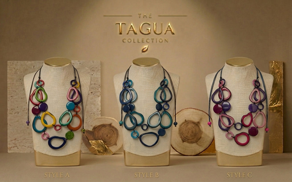 Three colorful abstract pendant necklaces displayed on beige fabric mannequin busts against a warm beige background. The necklaces feature overlapping circular and looped tagua pendants in multiple colors including blue, purple, pink, green, yellow, and orange.