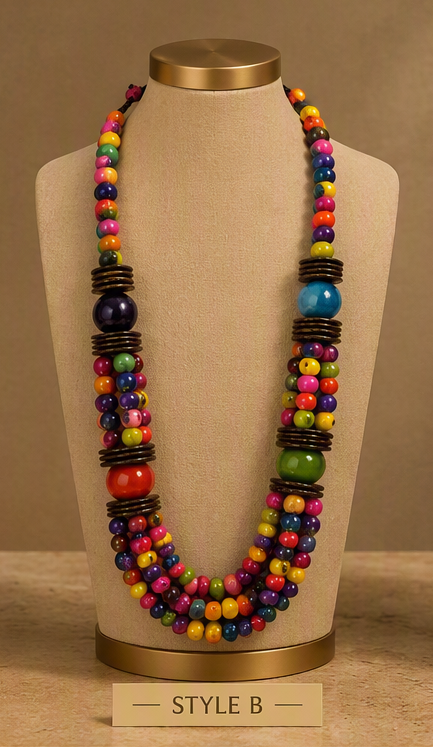 A multicolor beaded necklace displayed on a beige fabric jewelry bust. The necklace features small multicolored beads, larger colorful accent beads, and dark brown cylindrical spacer rings.