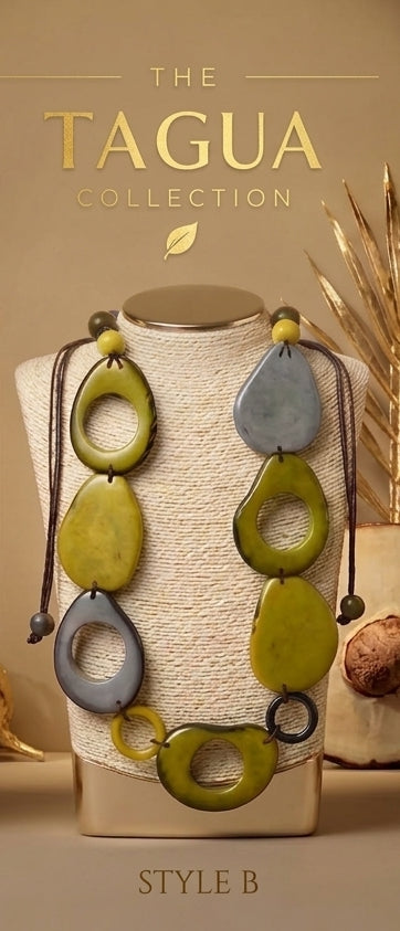 A necklace displayed on a beige fabric-covered jewelry bust. The necklace has large organic-shaped tagua beads in olive green, muted gray, and dark brown, with dark cord ties.