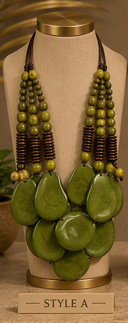 A multi-strand statement necklace displayed on a beige jewelry bust. The necklace features large, polished olive green teardrop-shaped beads layered over smaller olive green and dark brown beaded strands.