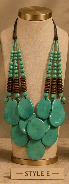 A statement bib necklace with large turquoise-green stone pendants and multiple strands of turquoise beads and dark brown cylindrical spacers, displayed on a beige jewelry bust.